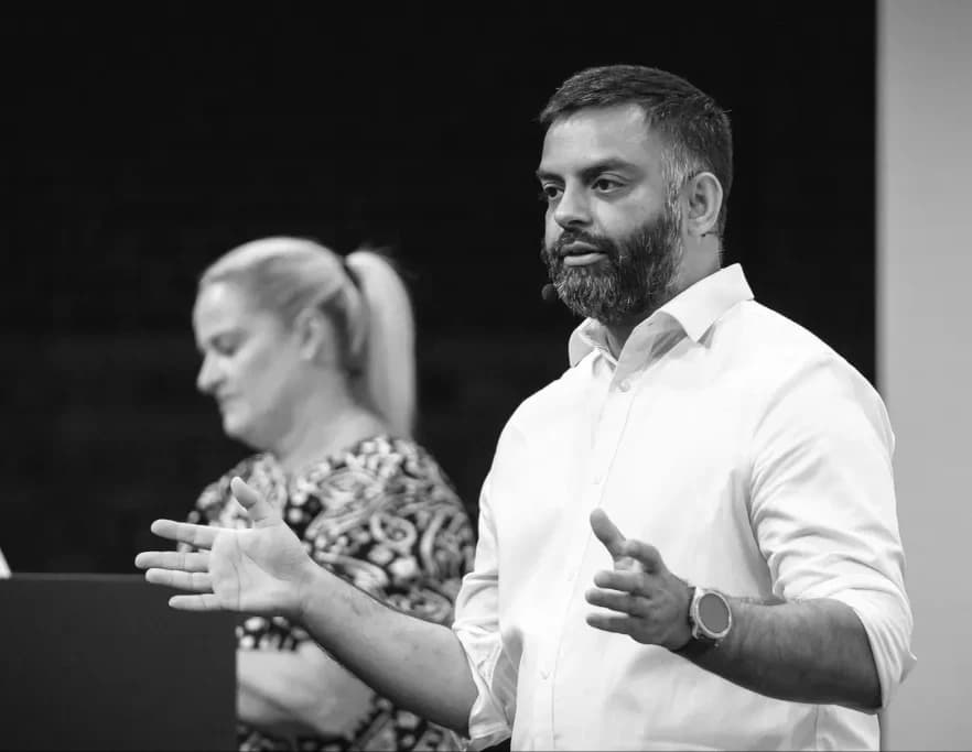 Two speakers presenting together on stage at CamundaCon