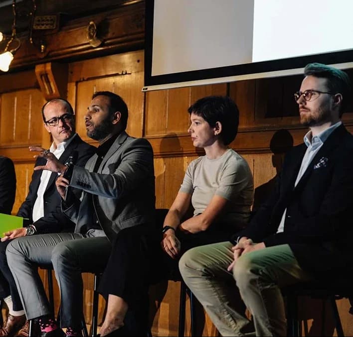 A panel discussion in a wood-panelled hall