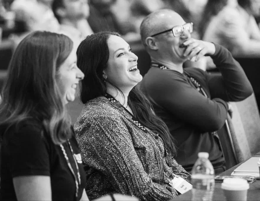 CamundaCon attendees laughing together in the audience